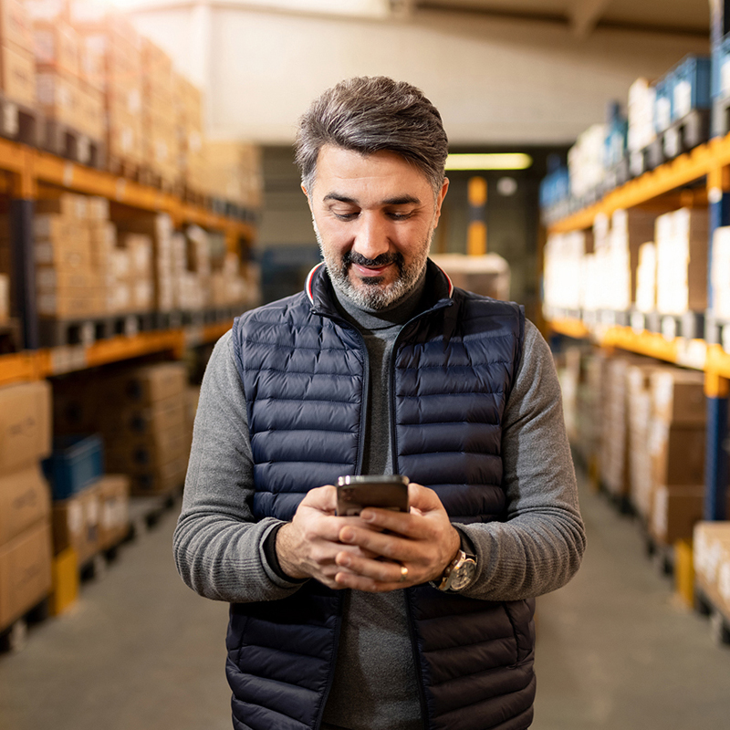 Featrued Business Callout - Man in warehouse with phone